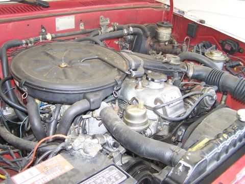 1988 Suzuki Samurai - Close-up view of a vehicle's engine compartment, showing various components and hoses.