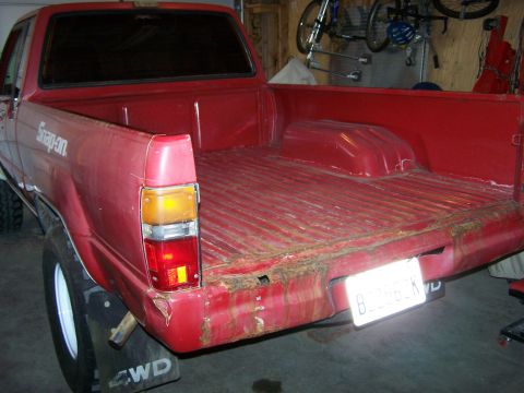 1988 Suzuki Samurai - Rear view of a red pickup truck bed showing rust damage and 'Snap-on' branding on the side.