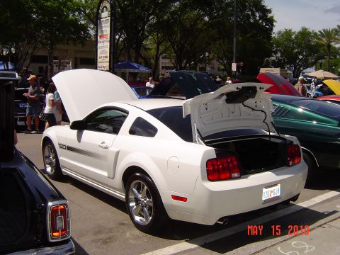 2005 Chevrolet Silverado 1500 - White Ford Mustang at a car show, rear view with trunk open. The event was held on May 15, 2010.