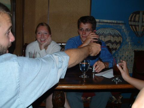 1993 Ford Taurus - A group of friends enjoys drinks at a table, with a decorative mural of hot air balloons in the background.