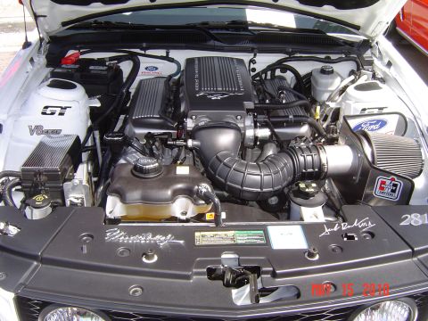 2005 Chevrolet Silverado 1500 - Engine bay of a Ford Mustang, a supercharged V8 engine with GT and V8 badges, and a signature from Jack Roush.