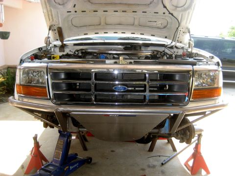 1996 Ford Bronco - Front view of a 1996 Ford Bronco with its hood up, supported by jack stands and an engine hoist.