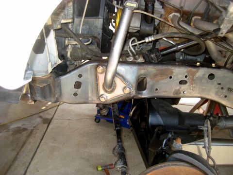 1996 Ford Bronco - Close-up view of a vehicle's front suspension components, including a custom-welded bracket.