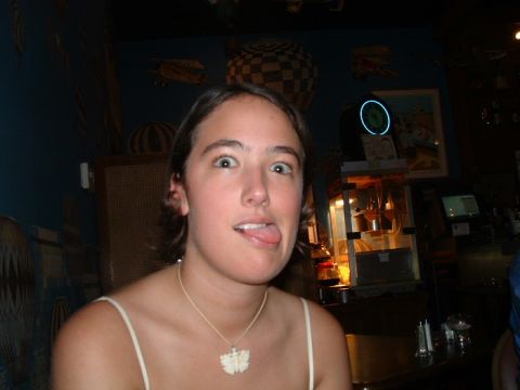 1993 Ford Taurus - A woman makes a silly face while wearing a butterfly pendant necklace.