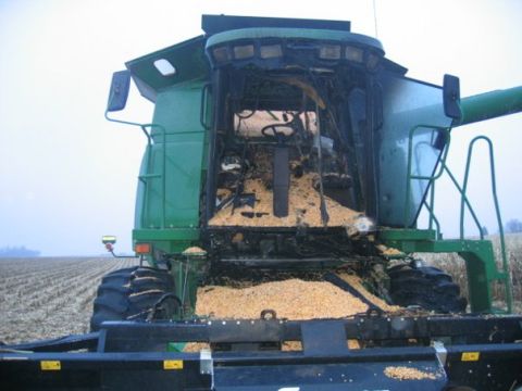 1994 Ford Bronco - The interior of a green combine harvester is visible, filled with corn kernels.