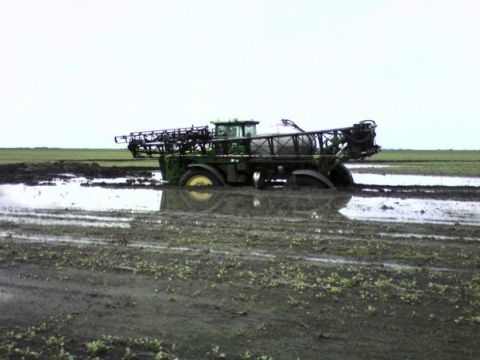1994 Ford Bronco - Tractor stuck in a muddy field after heavy rain.