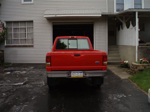 1997 Ford Ranger - A red 1997 Ford Ranger pickup truck is parked in front of a house.