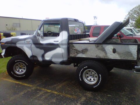 1995 Ford Bronco - This pickup truck features a unique camouflage paint job and a custom flatbed.