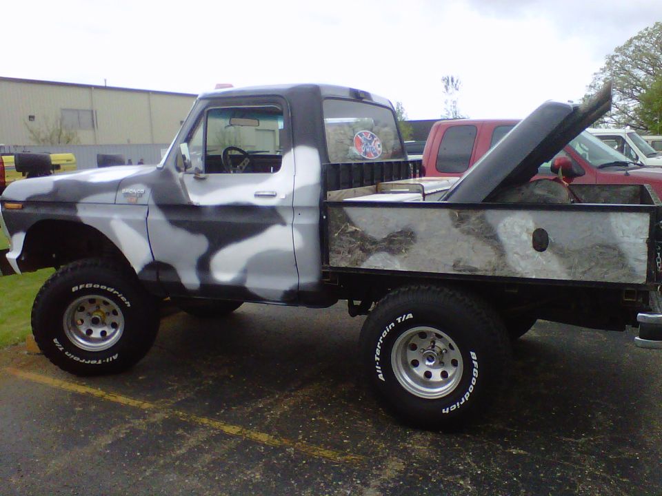Camo-painted lifted Ford Bronco pickup conversion on BFGoodrich A/T tires, side view