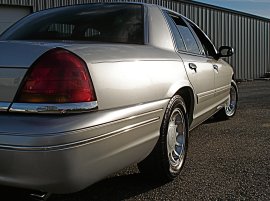 2000 Ford Crown Victoria - Rear view of a silver 2000 Ford Crown Victoria with chrome accents and aftermarket wheels.