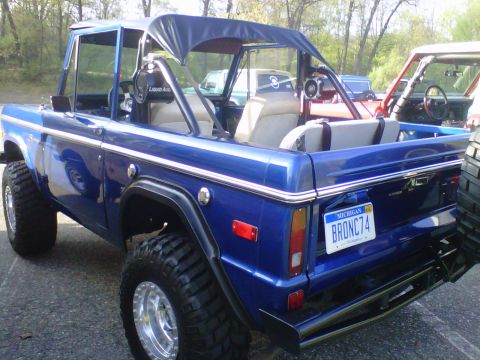 1995 Ford Bronco - This blue Ford Bronco has a custom roll cage and soft top, with a Michigan license plate reading BRONC74.
