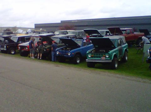 1995 Ford Bronco - Several Ford Broncos are lined up with their hoods open at an outdoor gathering.
