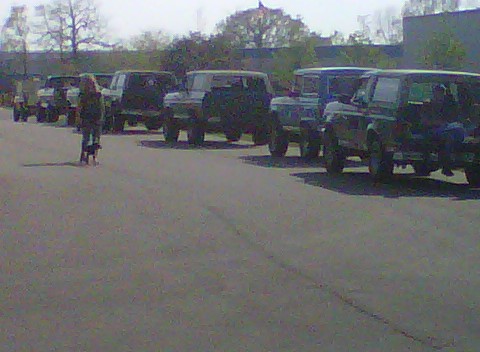 1995 Ford Bronco - A line of Ford Broncos are parked on asphalt with a person standing in front of them.