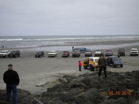 1994 Ford Explorer - A collection of SUVs and trucks are parked on a sandy beach with the ocean in the background. The date 05.15.2010 is visible.
