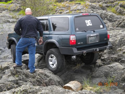 1994 Ford Explorer - A Toyota 4Runner navigates a rocky off-road course, with a man observing its progress.