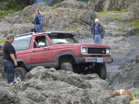 1994 Ford Explorer - A red 1989 Ford Bronco II navigates a challenging rocky trail. The date 05.15.2010 is visible in the lower right corner.