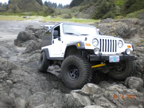 1994 Ford Explorer - White Jeep Wrangler Rubicon navigating rocky coastal terrain on May 15, 2010.