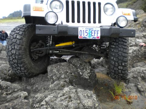 1994 Ford Explorer - A white Jeep Wrangler navigates rocky terrain near the coast, with the date 05/15/2010 visible.