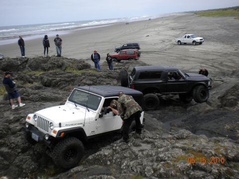 1994 Ford Explorer - Multiple off-road vehicles tackle a challenging rocky path near the coast on May 15, 2010.