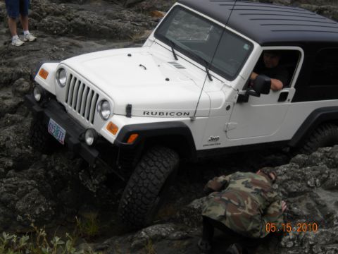 1994 Ford Explorer - Jeep Wrangler Rubicon navigating difficult rocky terrain with assistance from a spotter.