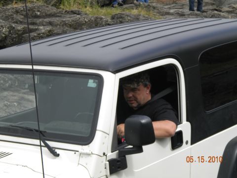 1994 Ford Explorer - Man driving a white Jeep Wrangler with a black hardtop. Date stamp visible on the vehicle.