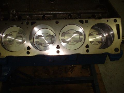 1969 Ford Torino - Close-up view of an engine block showing four pistons, with visible part numbers on some.