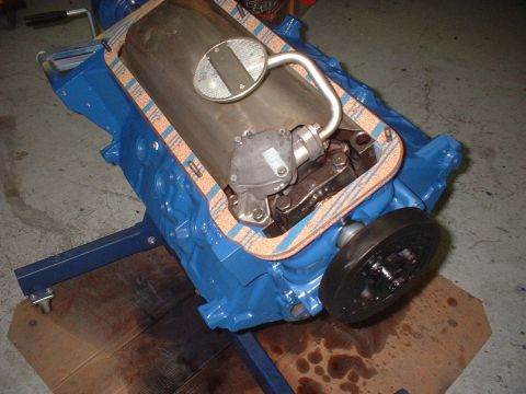1969 Ford Torino - Engine block assembly on a stand, showing the oil pump and pickup tube. The registry claims it is a 1969 Ford Torino, but this is a part, n…