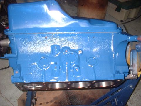 1969 Ford Torino - A blue engine block is shown on a stand, with visible cylinder bores and mounting hardware.