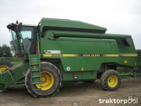 1994 Ford Bronco - Side view of a green John Deere 2064 combine harvester with large yellow wheels.