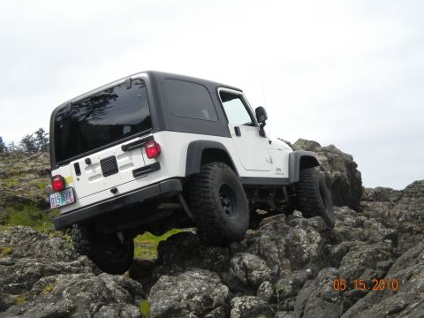 1994 Ford Explorer - A white Jeep Wrangler is shown traversing a challenging rocky landscape, with a date stamp of 05.15.2010 visible.