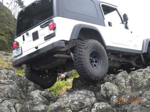 1994 Ford Explorer - Jeep Wrangler TJ navigating rocky terrain off-road.