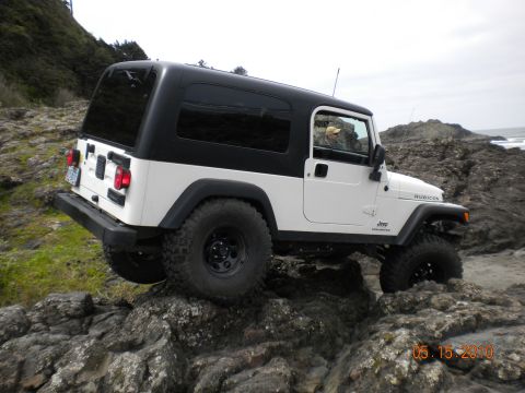 1994 Ford Explorer - A white Jeep Wrangler Rubicon navigates rocky terrain near the coast on May 15, 2010.