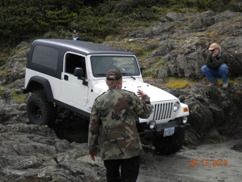 1994 Ford Explorer - White Jeep Wrangler on rocky terrain with two people nearby. Date stamp reads 05.15.2010.