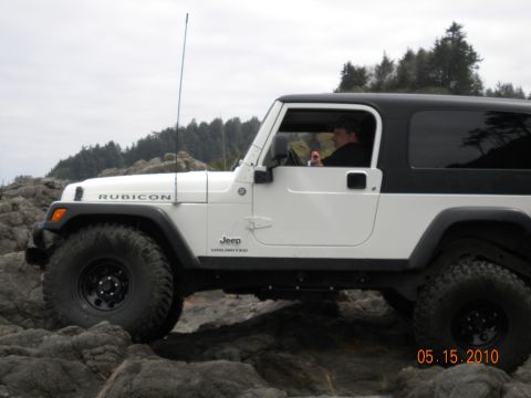 1994 Ford Explorer - A white Jeep Wrangler Rubicon Unlimited navigates a rocky coastal path on May 15, 2010.