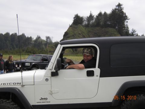 1994 Ford Explorer - Driver in a white Jeep Wrangler, with a black SUV in the background on an overcast day.