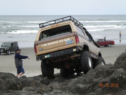 1994 Ford Explorer - Ford Bronco tackles rocks on the beach, with other vehicles nearby. Date stamp reads 05.15.2010.