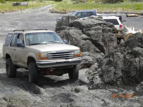 1994 Ford Explorer - 1994 Ford Explorer navigating a rocky coastal trail with other vehicles nearby.