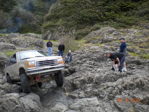 1994 Ford Explorer - 1994 Ford Explorer navigating a challenging rocky path near the coast.