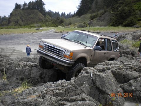 1994 Ford Explorer - 1994 Ford Explorer navigating a rocky coastal terrain.