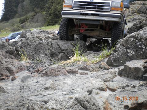 1994 Ford Explorer - A 1994 Ford Explorer navigates a rocky coastal terrain, with another vehicle visible in the background.