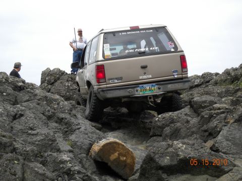1994 Ford Explorer - A tan 1995 Ford Explorer navigates a rocky terrain, with two people observing.