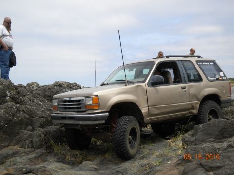 1994 Ford Explorer - 1994 Ford Explorer navigating a rocky trail with people inside and on top.