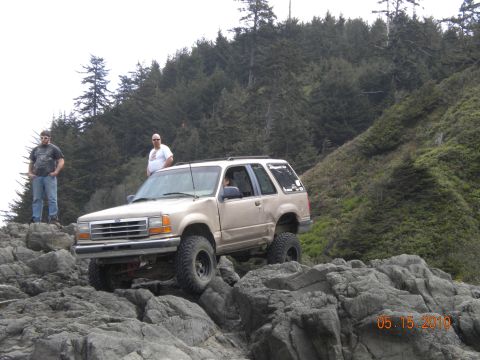 1994 Ford Explorer - 1994 Ford Explorer navigating rocky terrain with two people standing nearby.