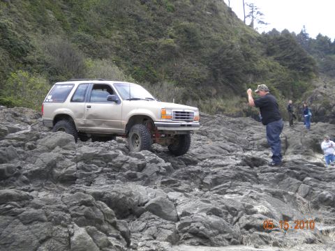 1994 Ford Explorer - Ford Explorer tackling a challenging rocky path by the ocean.