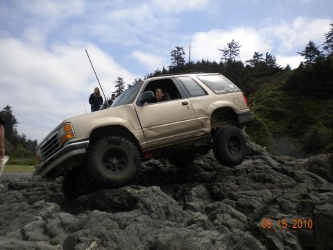 1994 Ford Explorer - 1994 Ford Explorer navigating rocky terrain near the coast.