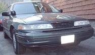1997 Ford Crown Victoria - A dark green sedan is parked outside, viewed from the front.