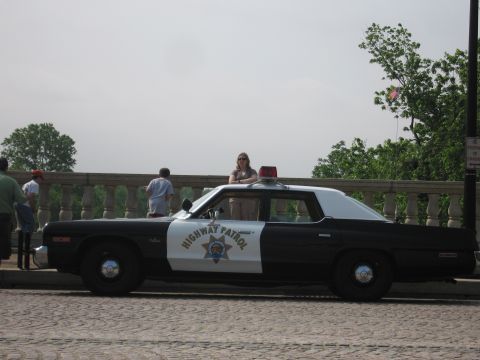 1991 Ford Crown Victoria - A side view of a vintage police car with "HIGHWAY PATROL" markings, suggesting an older model than claimed.