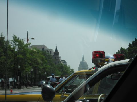 1991 Ford Crown Victoria - Police vehicles are parked on a street with the US Capitol building in the distance.