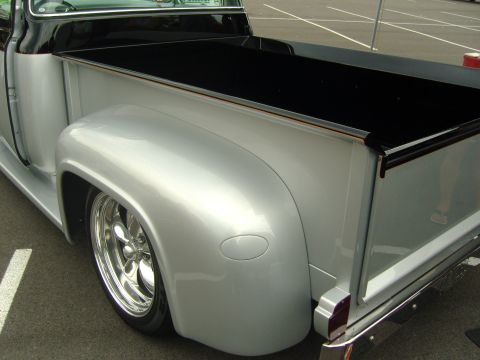 2007 Ford Mustang - This custom pickup truck features a two-tone silver and black paint scheme with a lowered stance and chrome wheels.