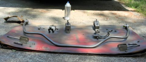 1976 Ford Ranchero - Suspension components are laid out on a board for painting.